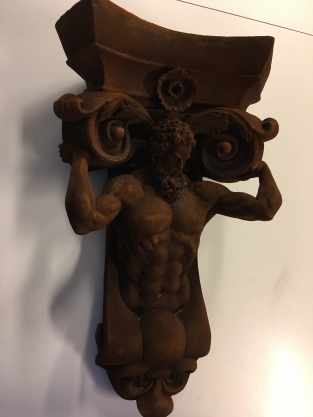 Very striking wall bracket -ornament with garing man, Polystone rest.